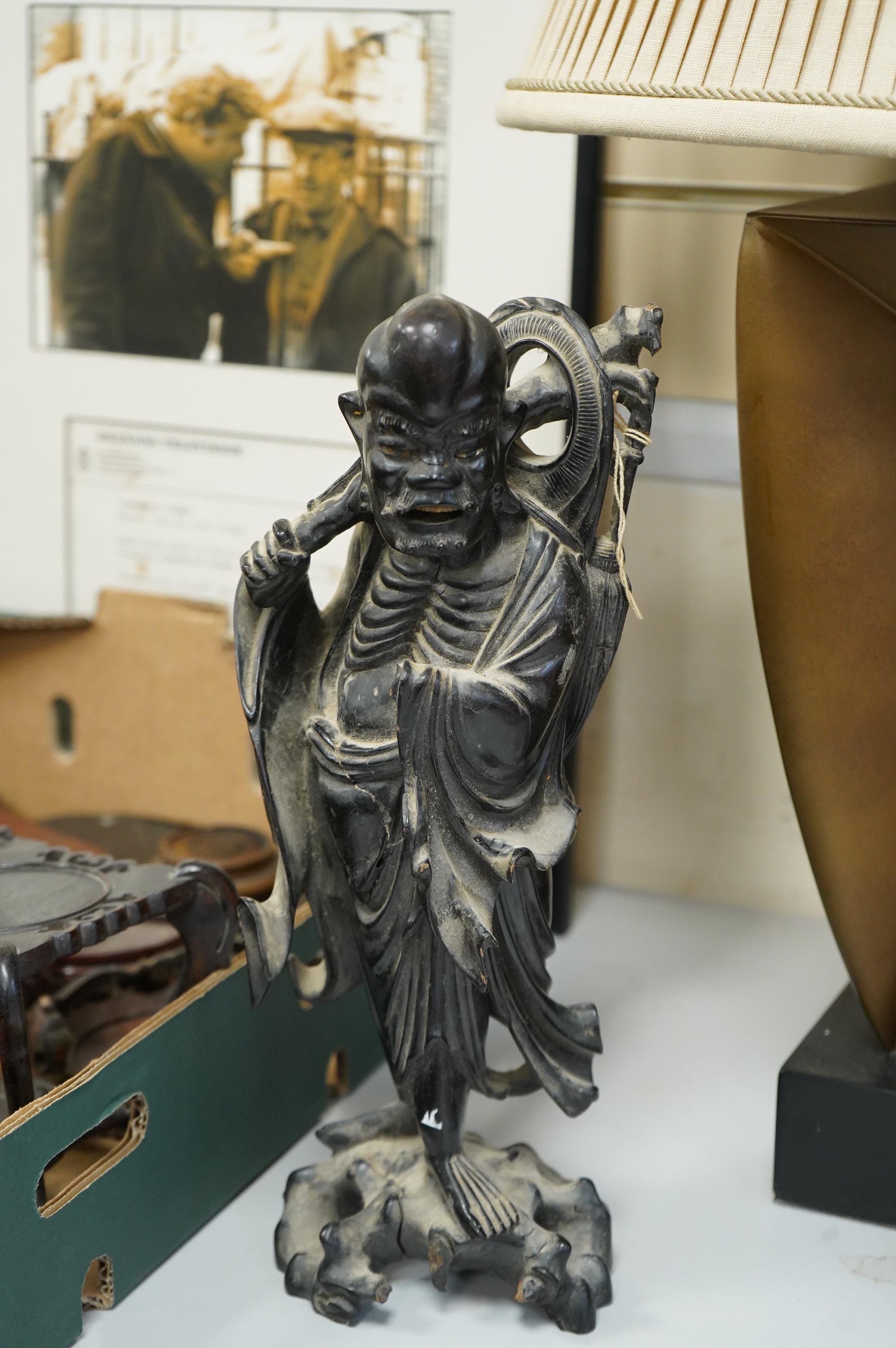 A collection of various Chinese stands, a carving of an ox and another